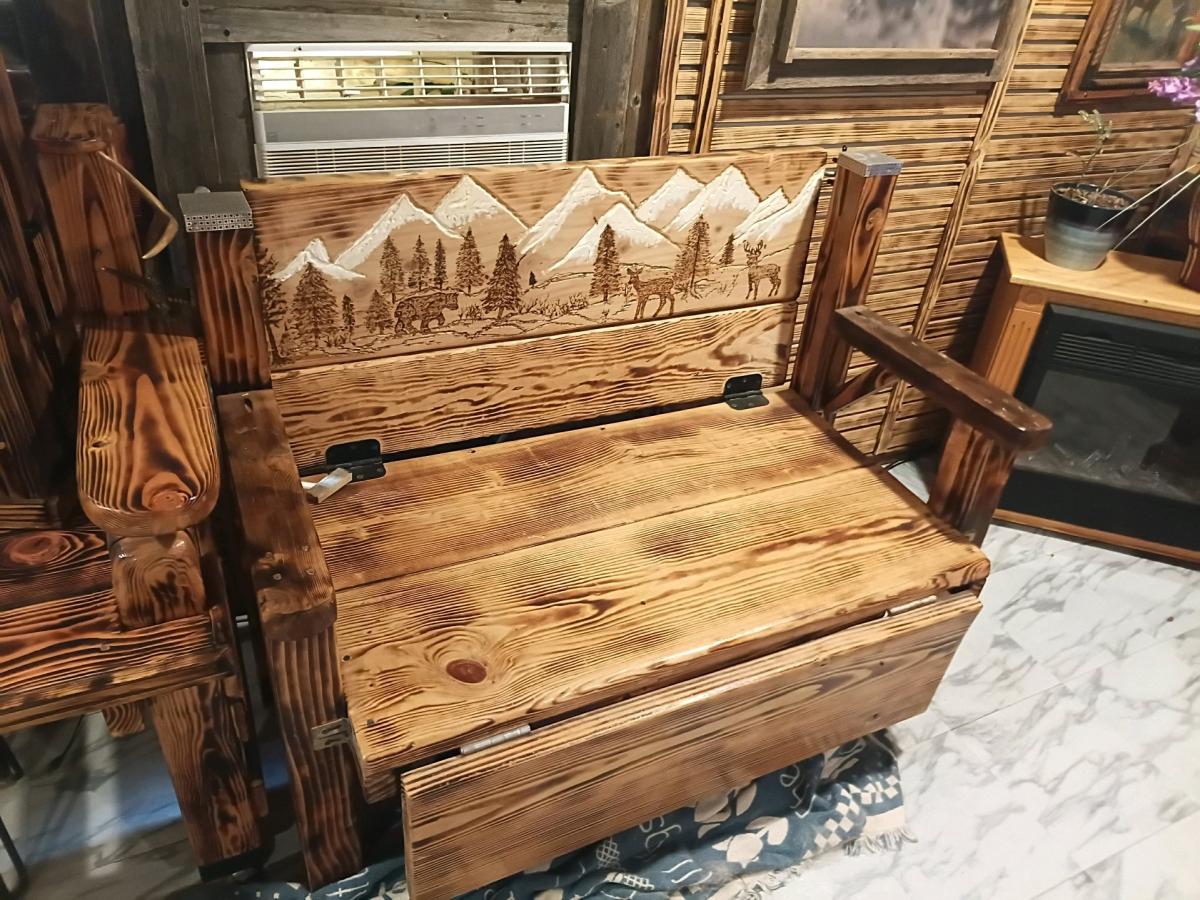 wood bench with hand carved picture on the back