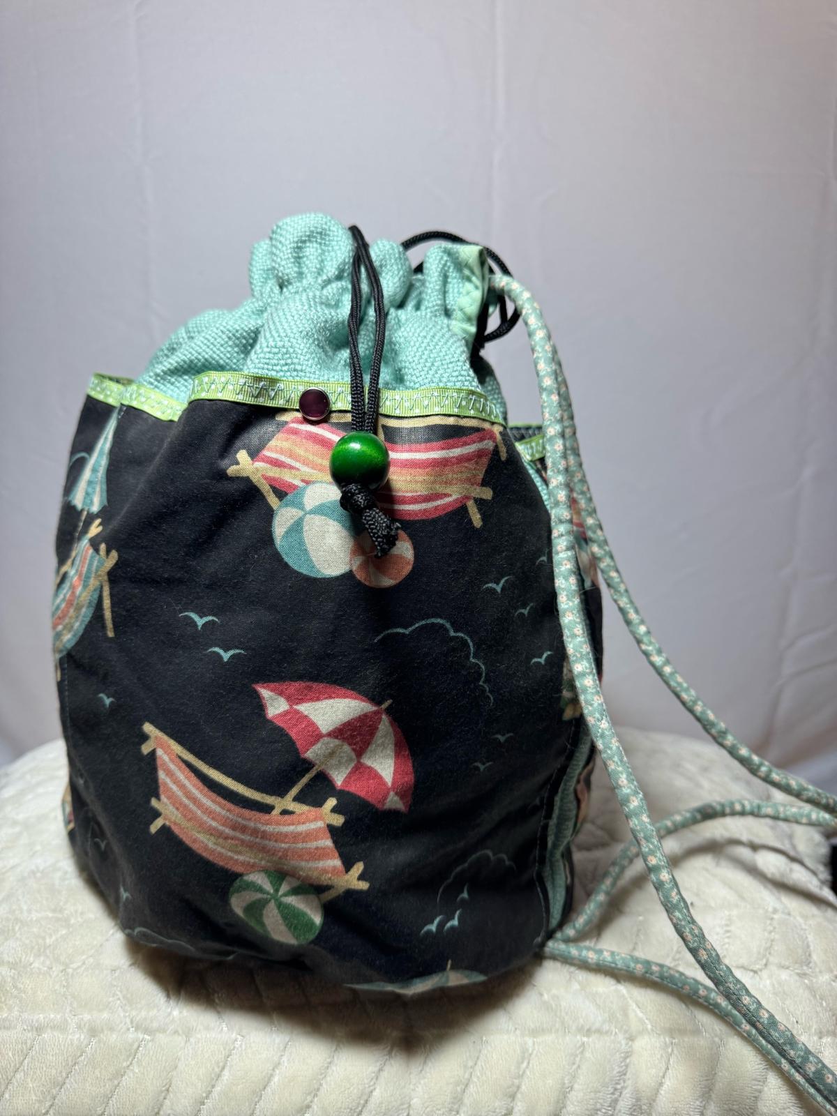 drawstring beach print bucket bag in mint and black