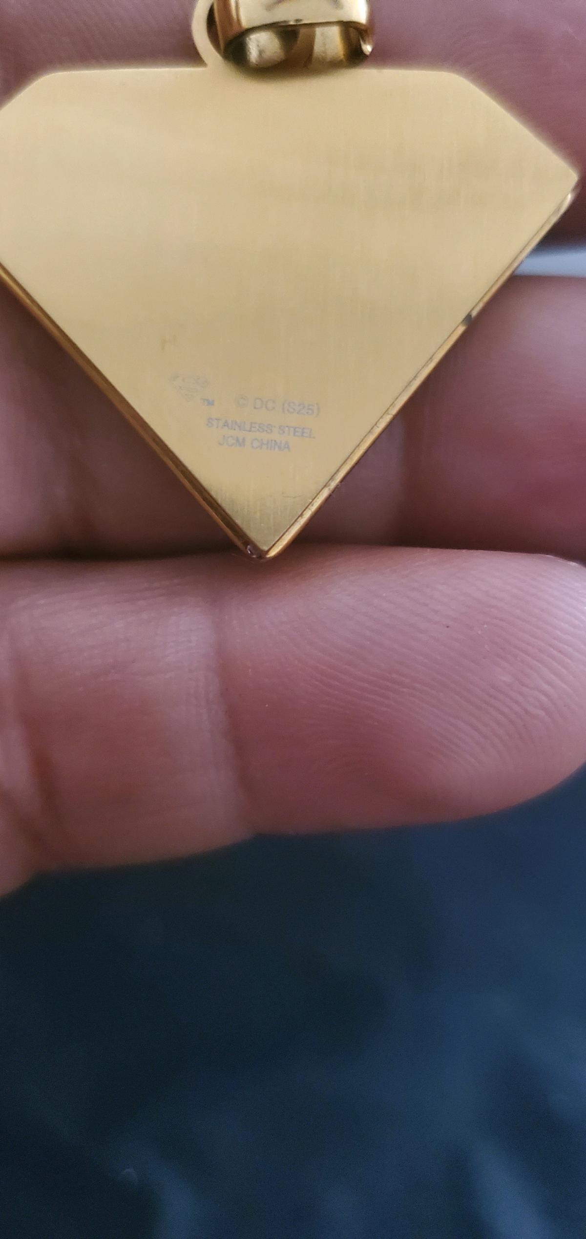 goldtoned Superman S shield pendan