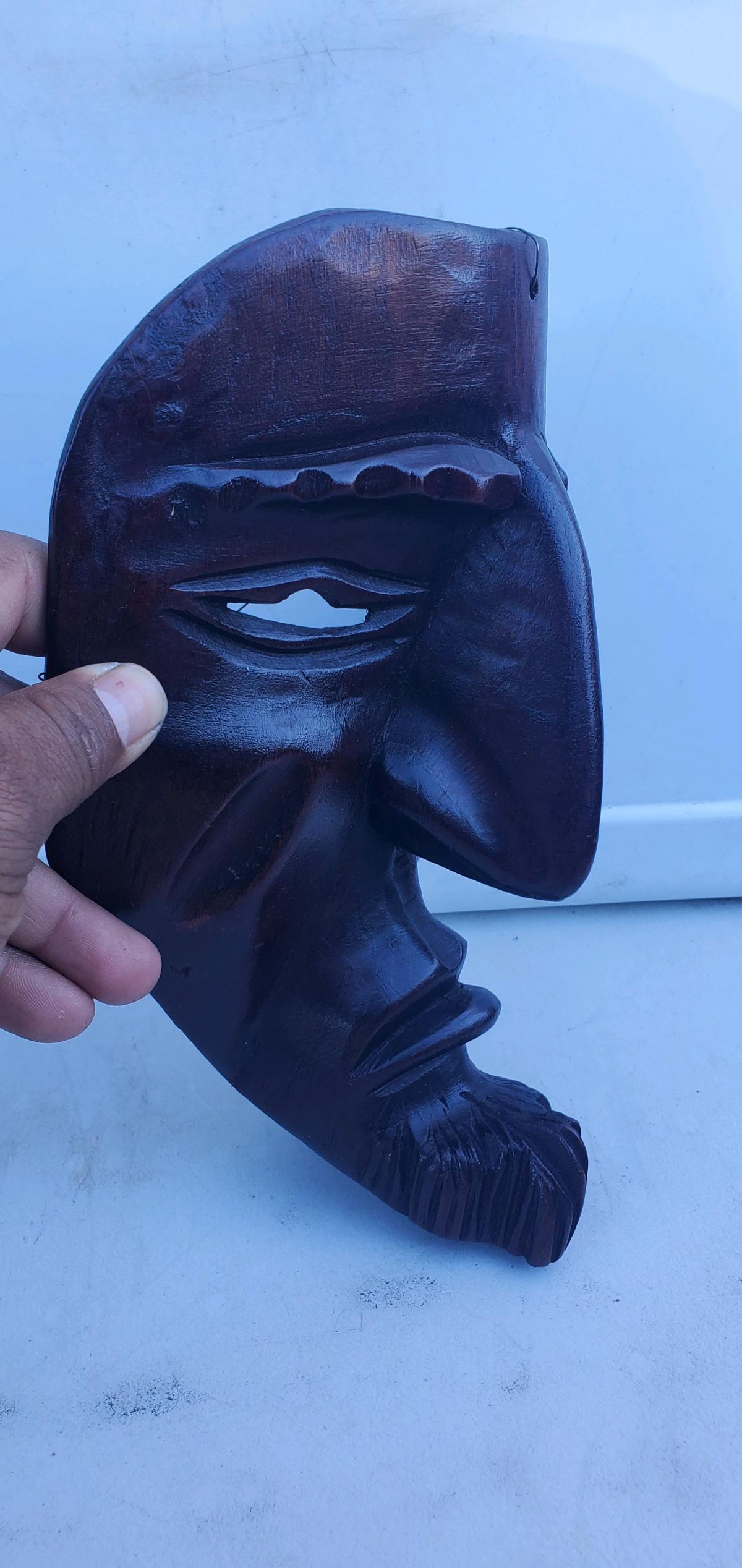handcarved dark wood wall mask