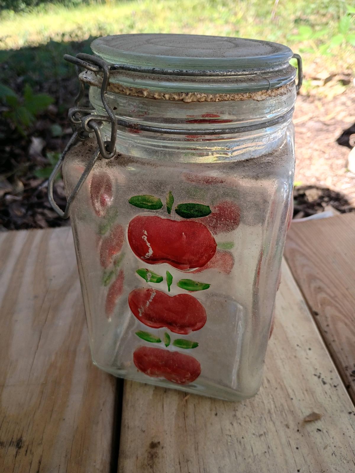 A Vintage Tall  Apple Glass Canister with Seal Snap  Lid