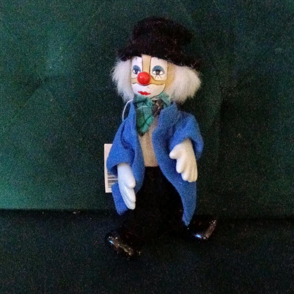 Vintage porcelain clown doll with white painted features