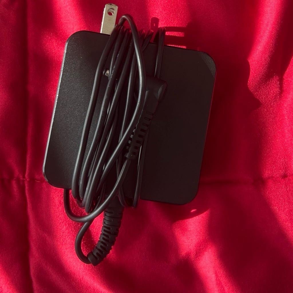 computer and  shirts and shoes and charger
