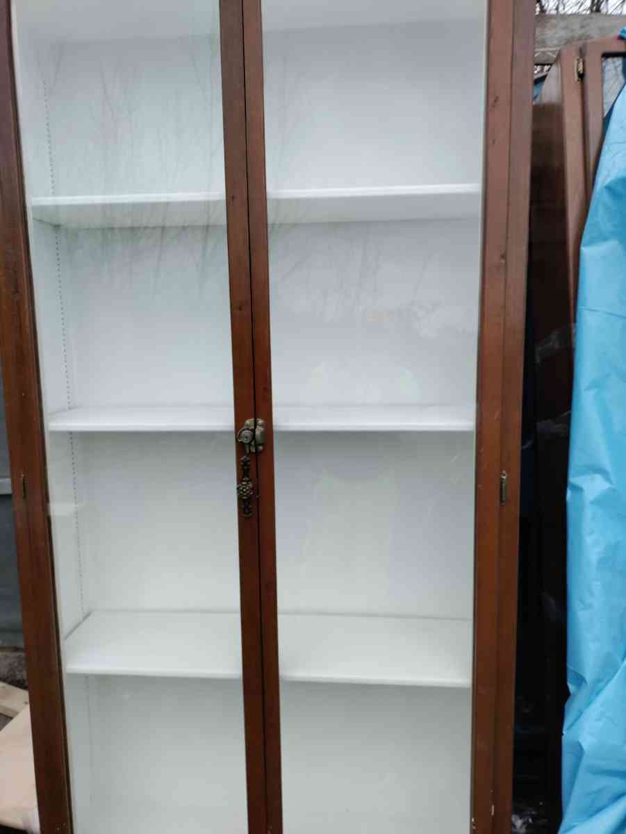 two very tall vanities or display cases