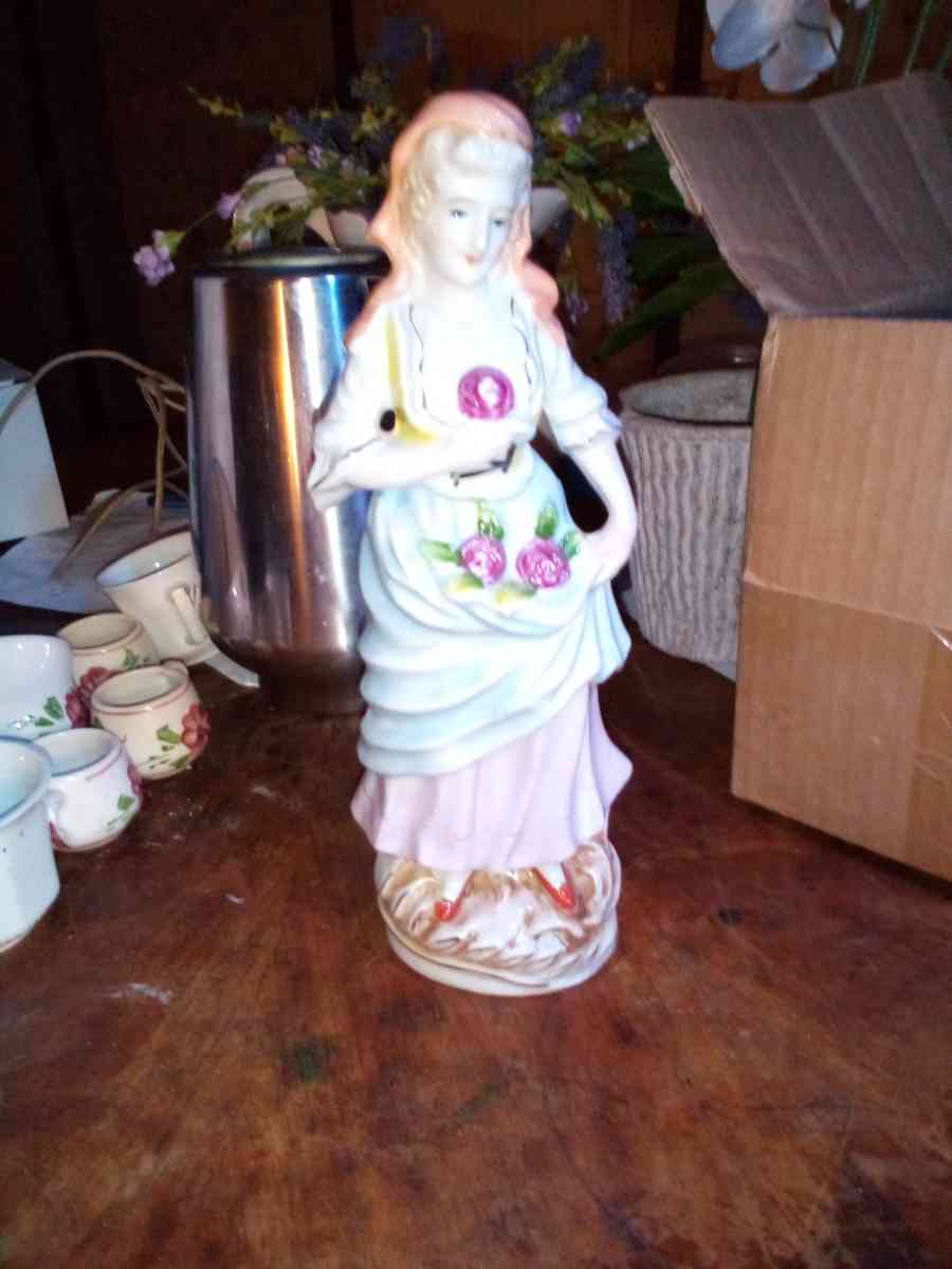 collectible vintage lady holding flower stand