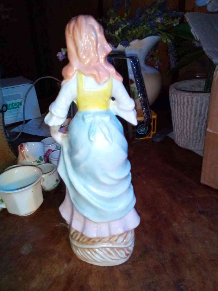 collectible vintage lady holding flower stand