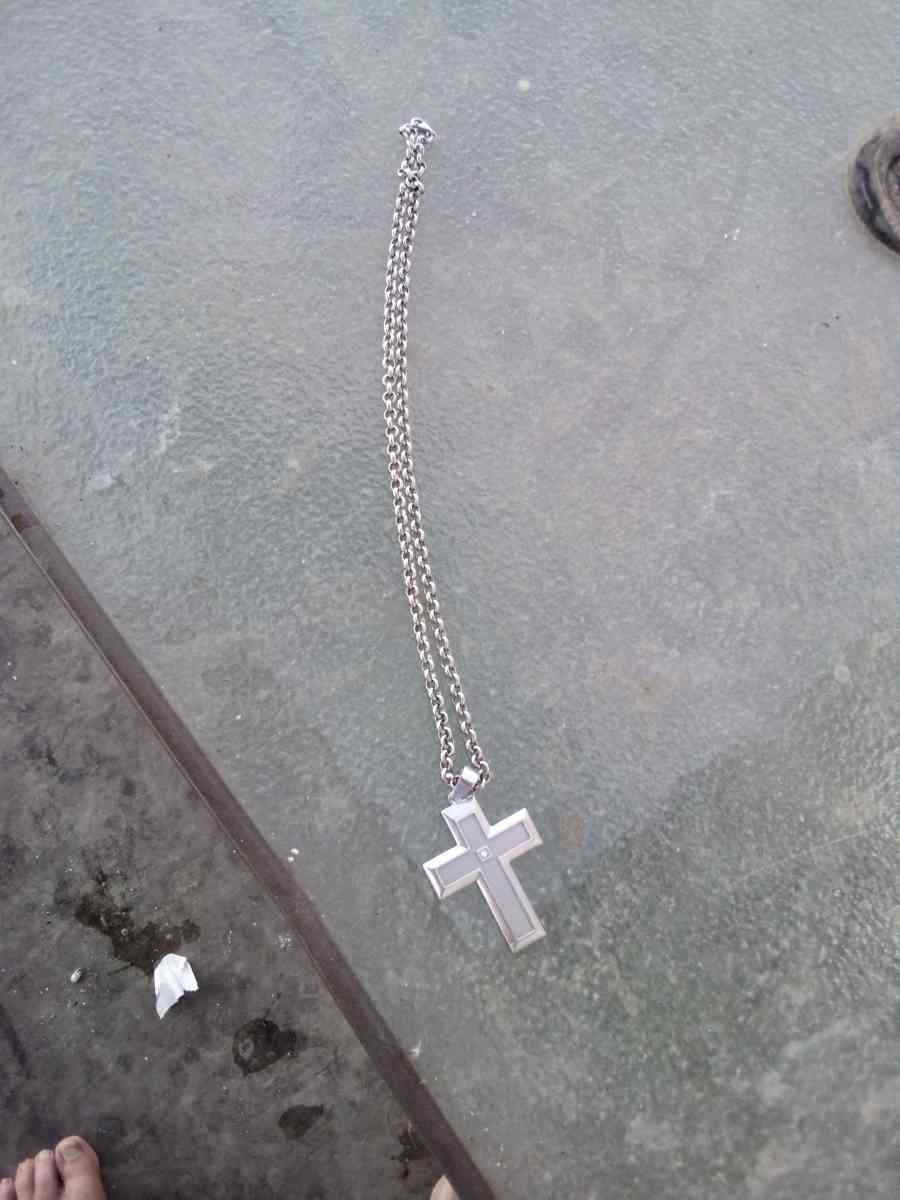 sterling silver necklace with a cross and a diamond in the m