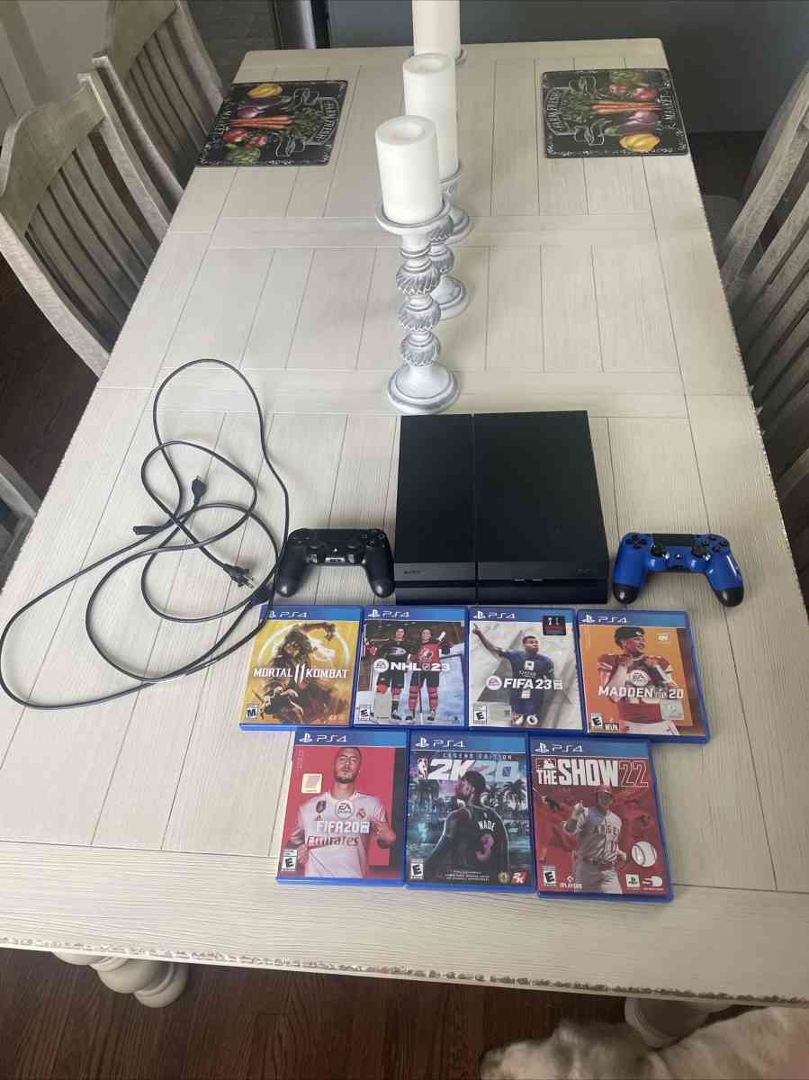 PlayStation 4 with games and controllers