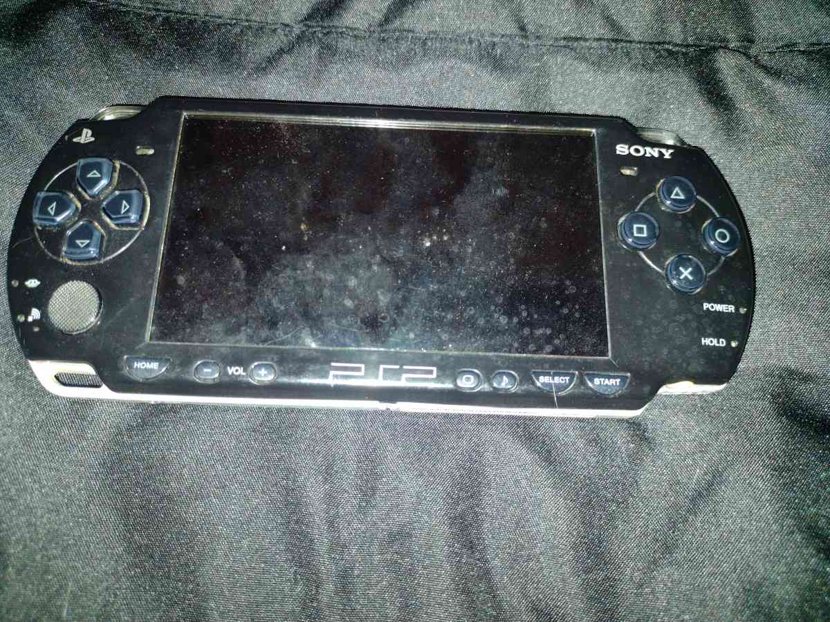 psp with charger and two games