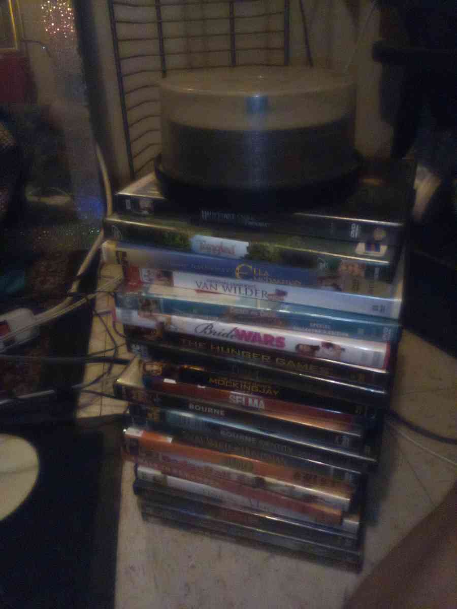 several DVDs and a big DVD holder