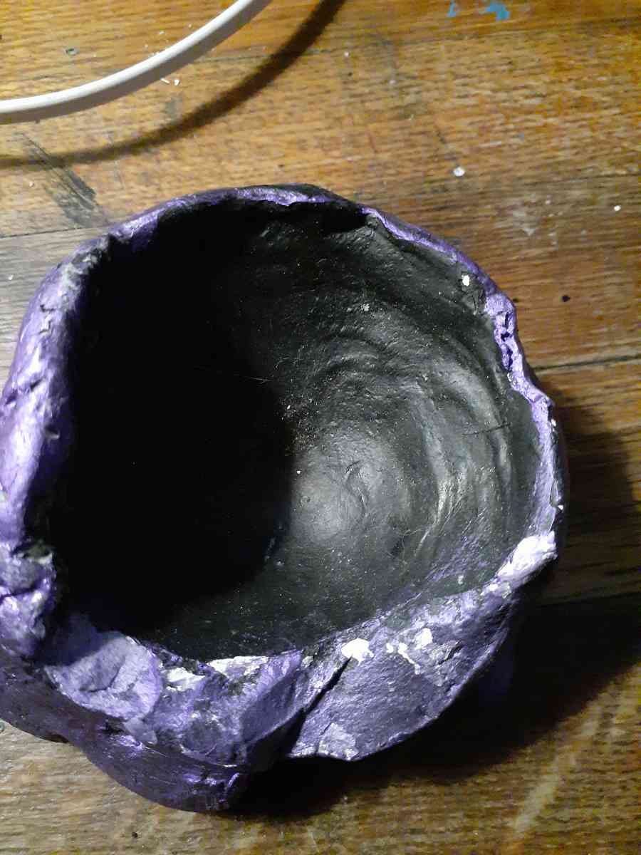 purple and black piece of pottery