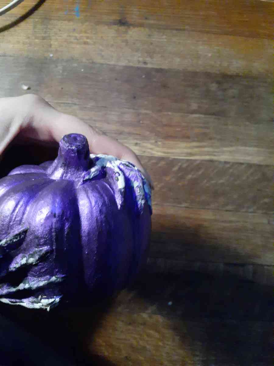 purple Halloween pumpkin with skeleton hands