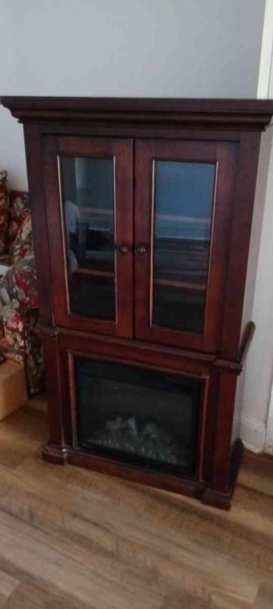 Wood curio cabinet with electric fireplace