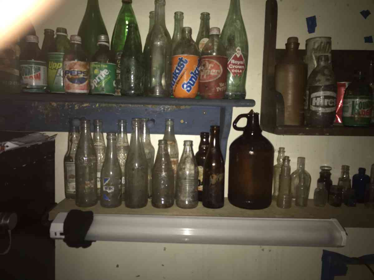 old soda bottles and beer bottles and others