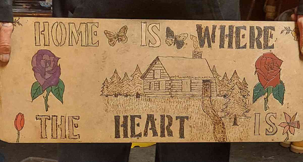 wood burned sighn home is where the heart is
