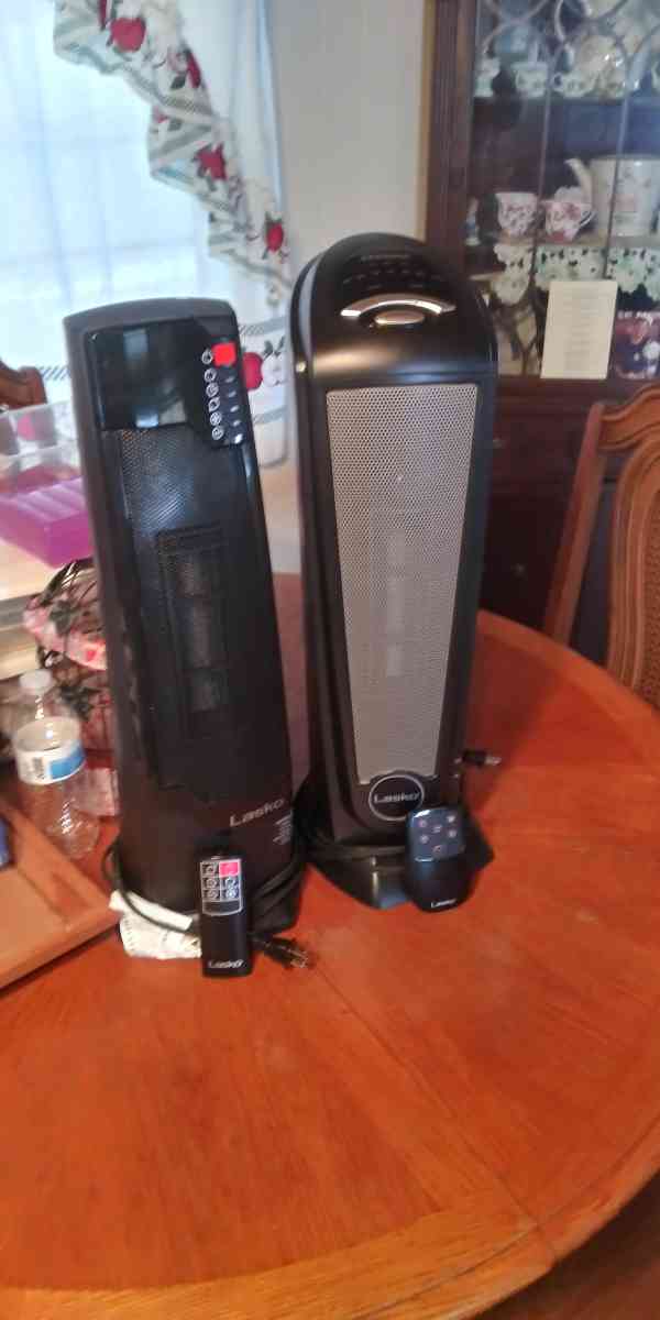 two ceramic oscillating tower heaters with remote control