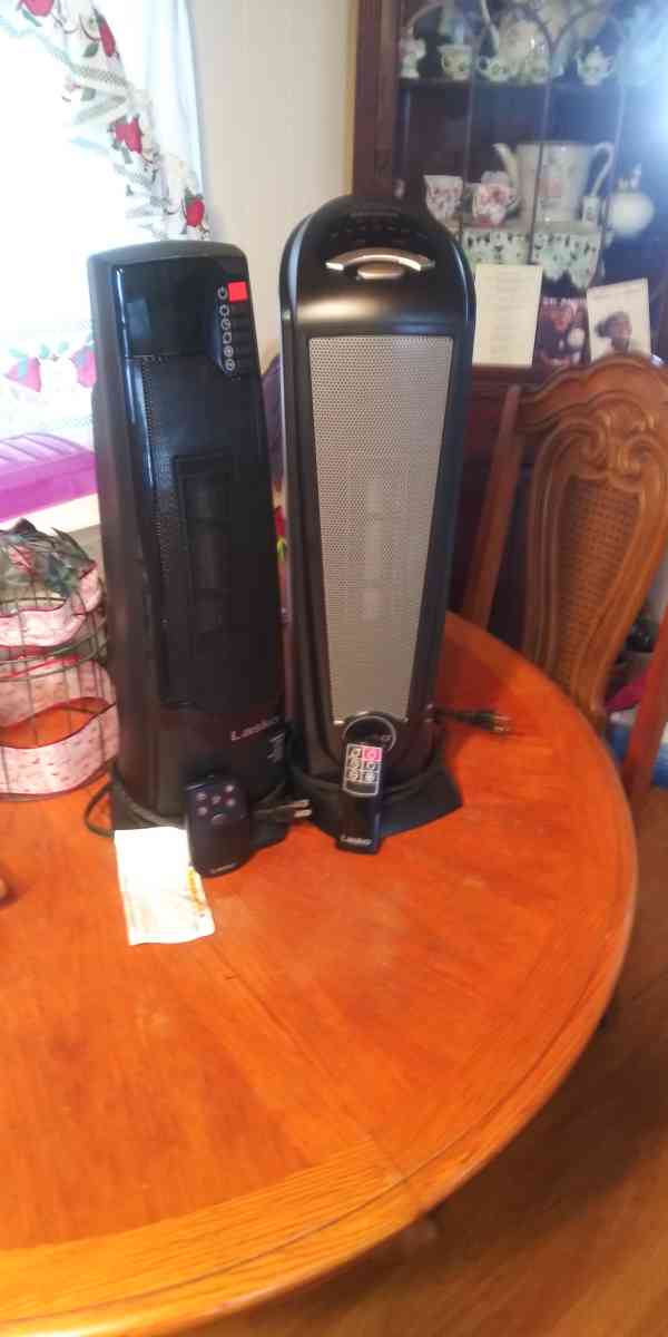 two ceramic oscillating tower heaters with remote control
