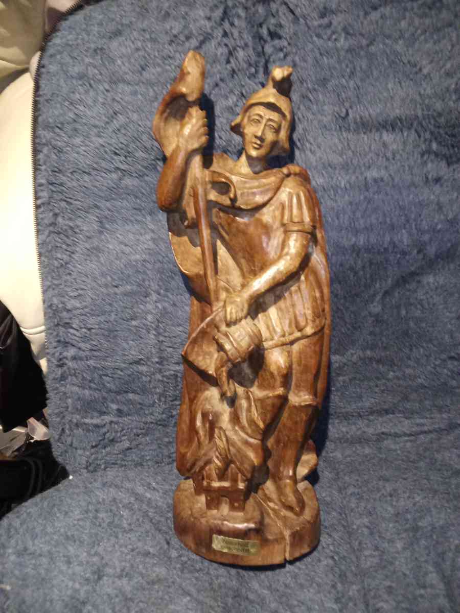 wood carving of a Roman firefighter