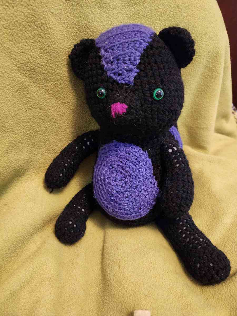 Spunky the black and purple Skunk