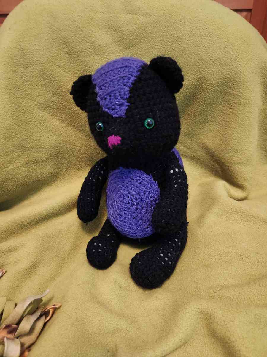 Spunky the black and purple Skunk