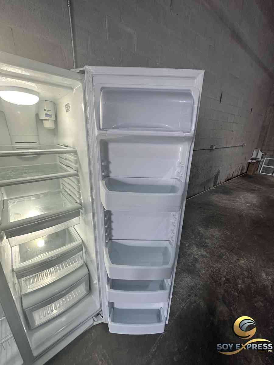 GE refrigerator side by side with ice and water dispenser