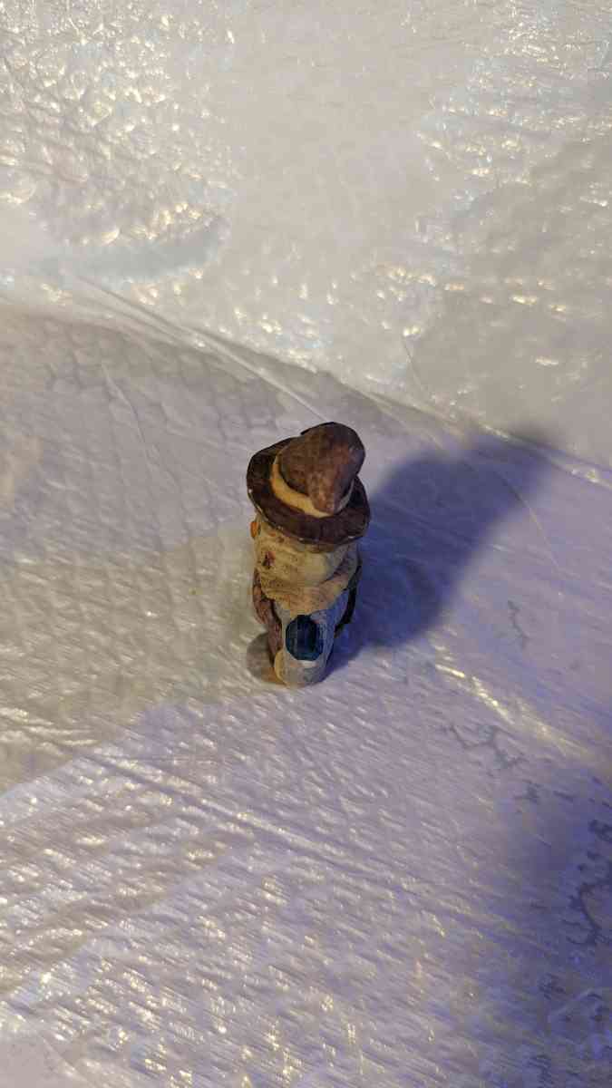 Happy Wood Scarecrow has a couple of Pumpkins and a little S