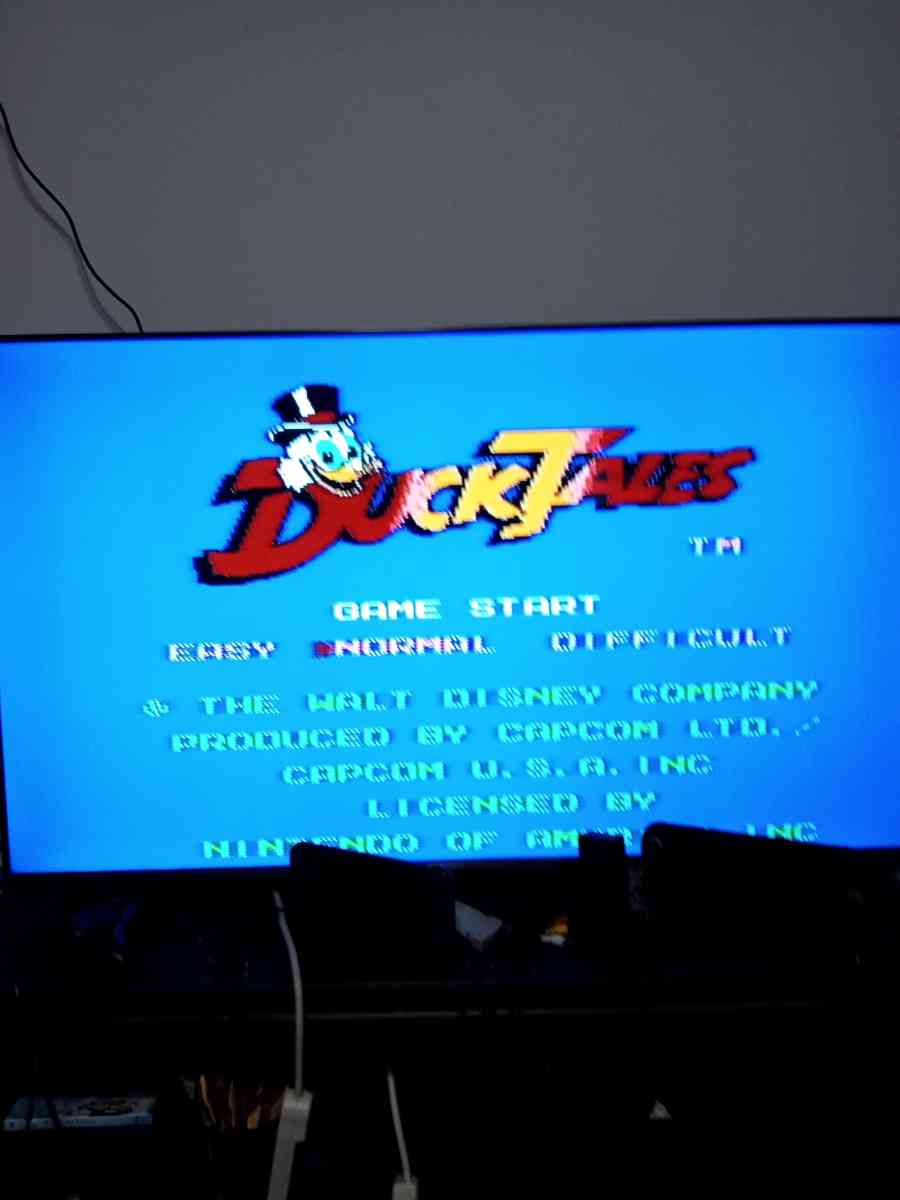 2 Nintendo NES consoles with 3 controllers and 5 games