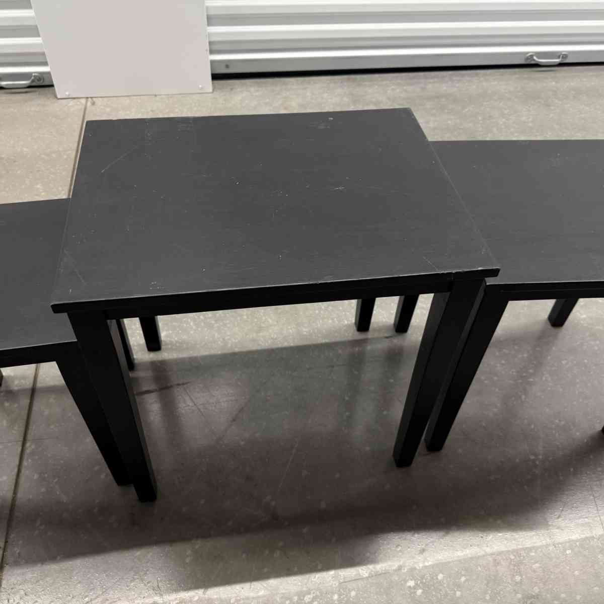 3 black tables slide under the other for easy storing used