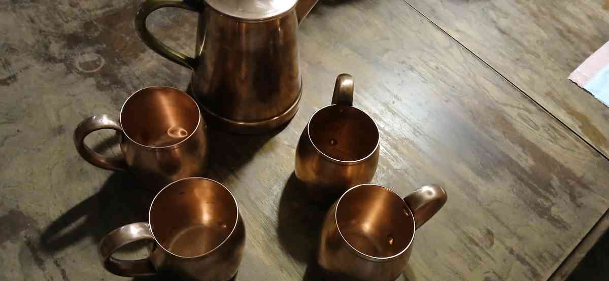 solid copper cups and a coffee pot
