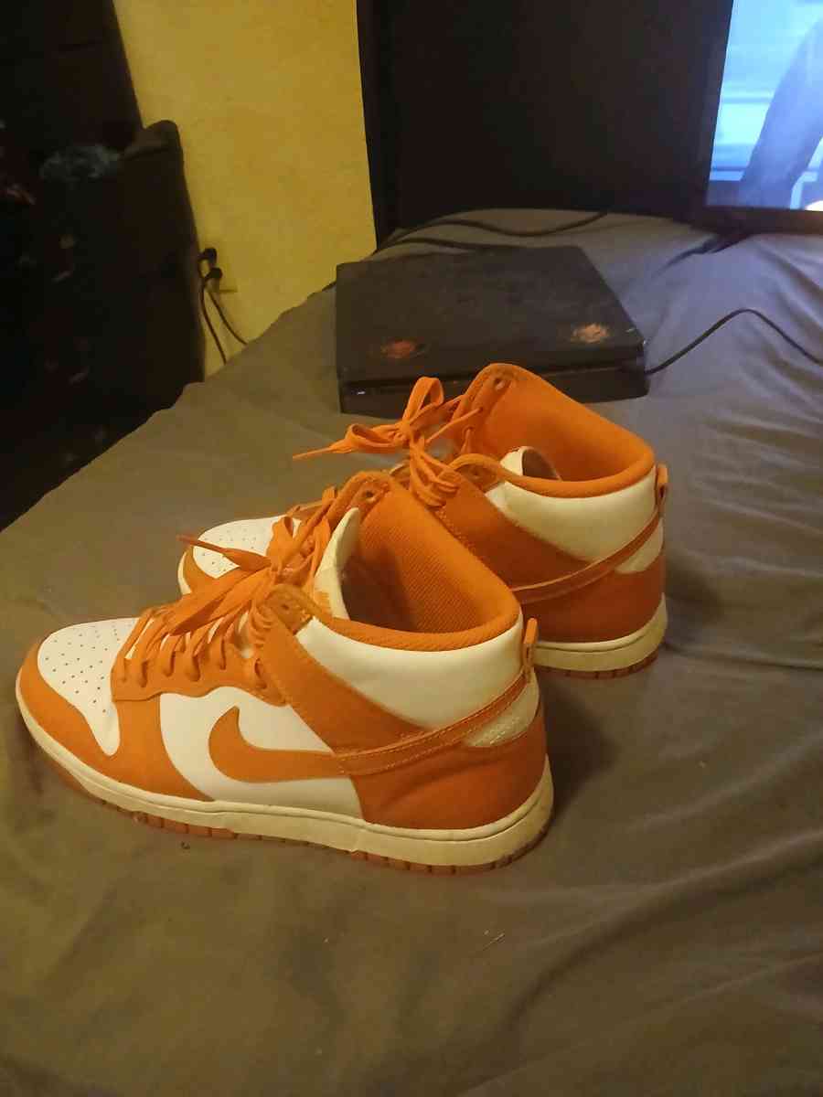 orange and white  Nike  shoes