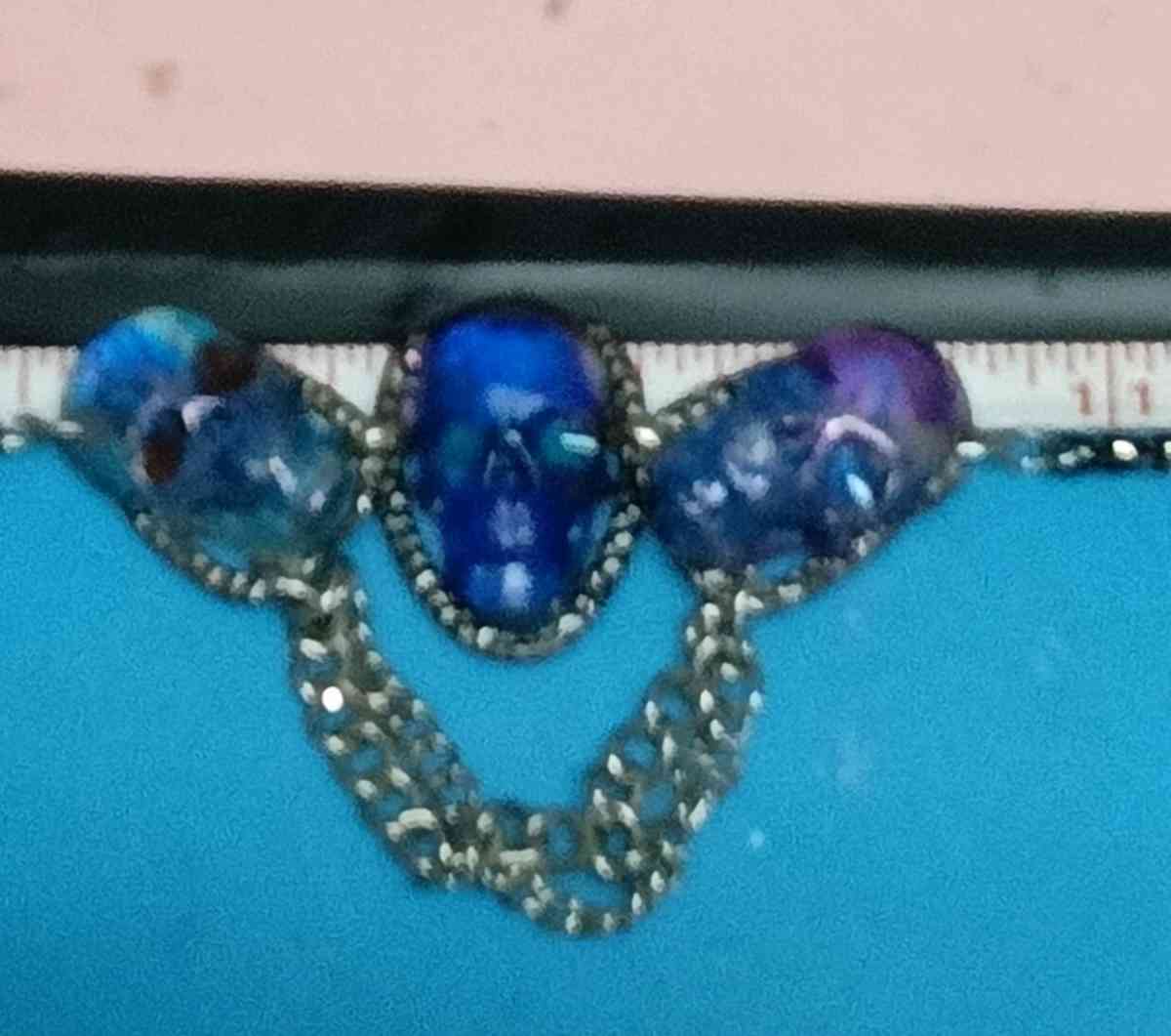 three skulls with multiple chains made with Uv resin