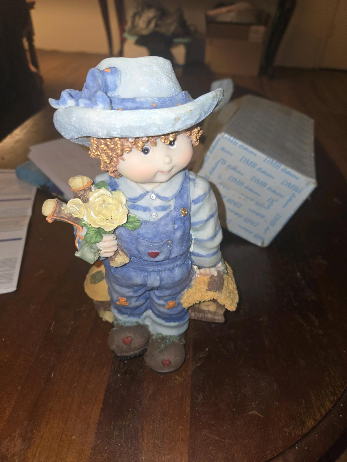 boyfigurine with blue overalls and hat and flowers - Taylorsville, North Carolina - FleaMarketBay