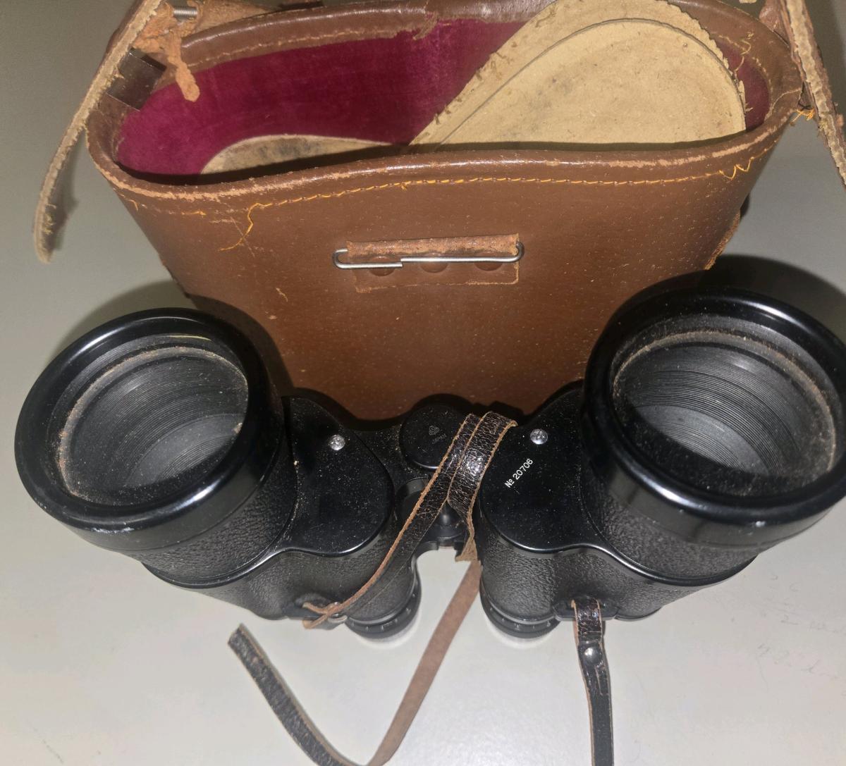 The image shows a pair of vintage black field binoculars wit - Linthicum Heights, Maryland - FleaMarketBay