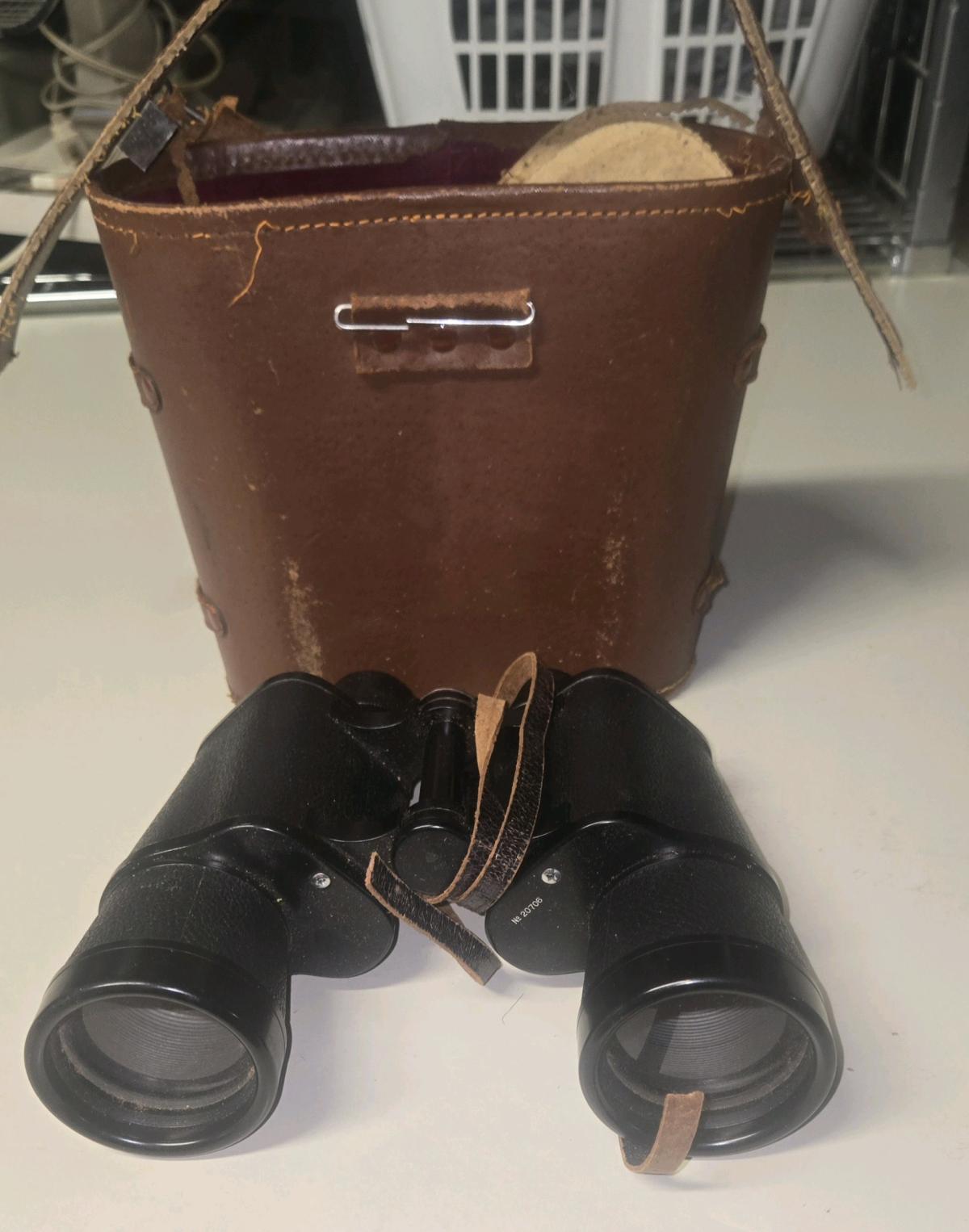 The image shows a pair of vintage black field binoculars wit - Linthicum Heights, Maryland - FleaMarketBay