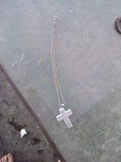 sterling silver necklace with a cross and a diamond in the m