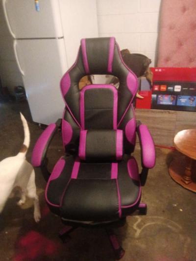 Pink and black gaming chair with vibrating pillow