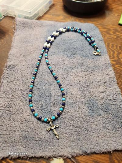 silver cross with glass bead necklace