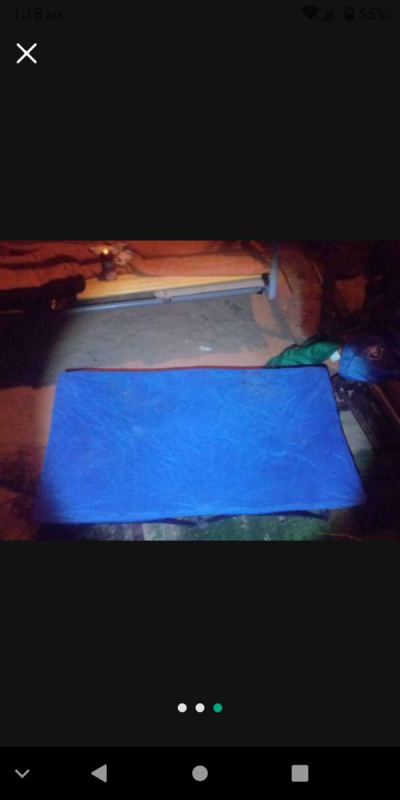 two foldable chairs with cup holders and one foldable cot