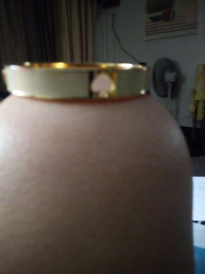a black bracelet and a white Kate Spade bracelet - Thumbnail 3