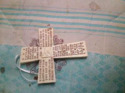 a religious wall hanging and two pairs of hand made earrings