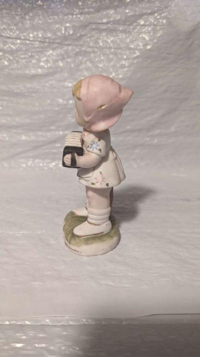 A Little Girl Playing an Accordion with a White Dress - Thumbnail 2