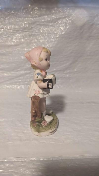 A Little Girl Playing an Accordion with a White Dress - Thumbnail 4