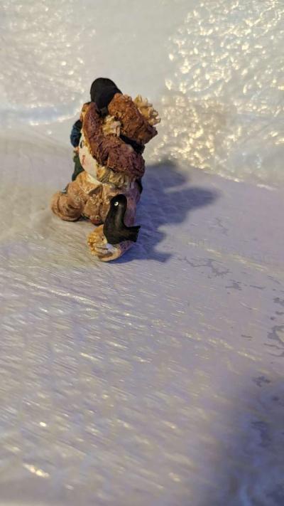 Resin Scarecrow Laying Down With Legs Bent Holding A Crow - Thumbnail 2