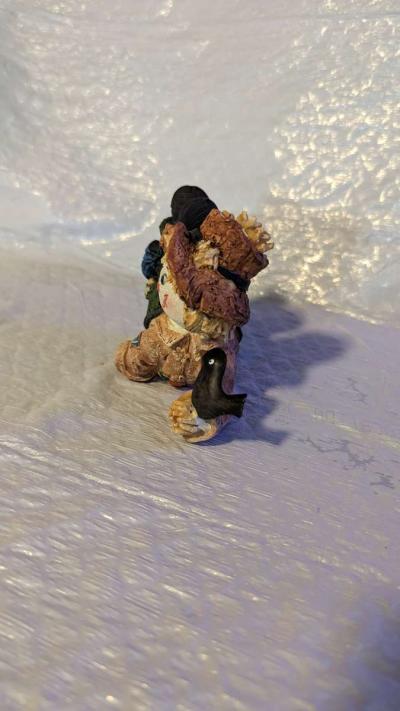 Resin Scarecrow Laying Down With Legs Bent Holding A Crow - Thumbnail 3