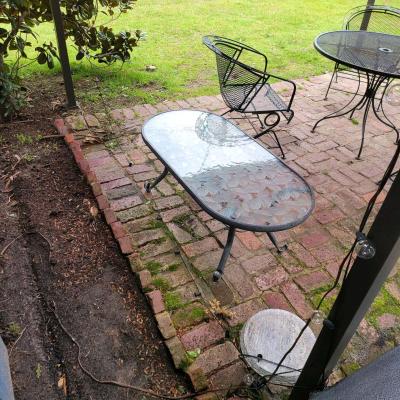 Oval outdoor glass coffee table with metal trim