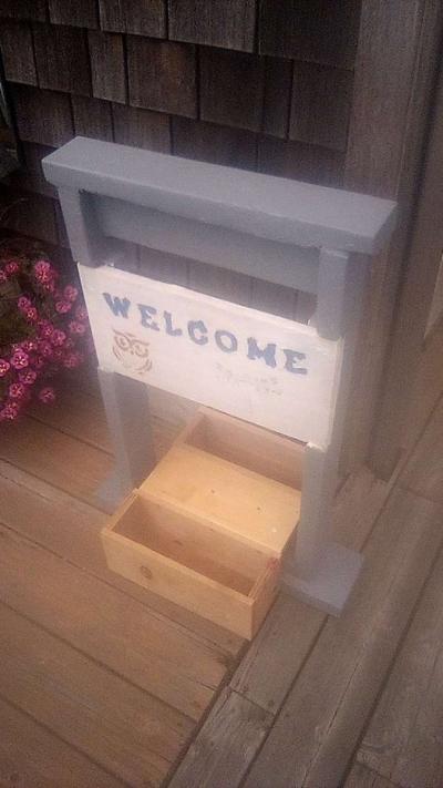 welcome sign with planters