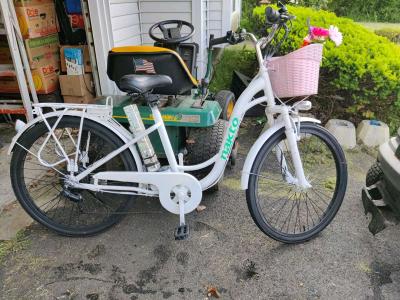 White used ebike with pink basket