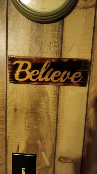 torched Believe sign