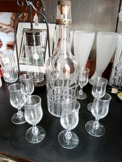 Bottle with etched glass and shot glasses