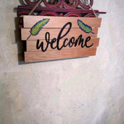 wood welcome sign handmade with feathers